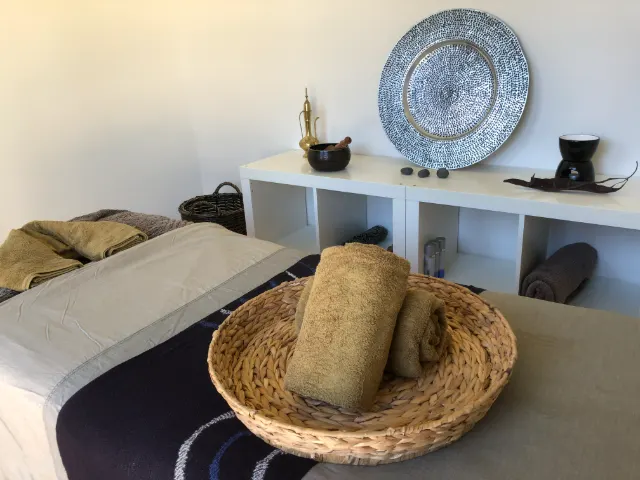 Rolled towels in a woven basket